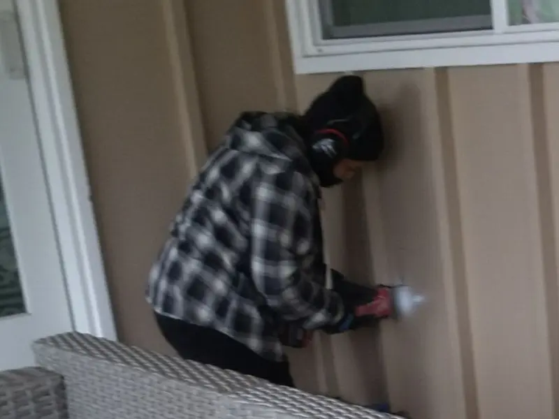 Professional electrician installing an exterior outlet in Lake Wissota