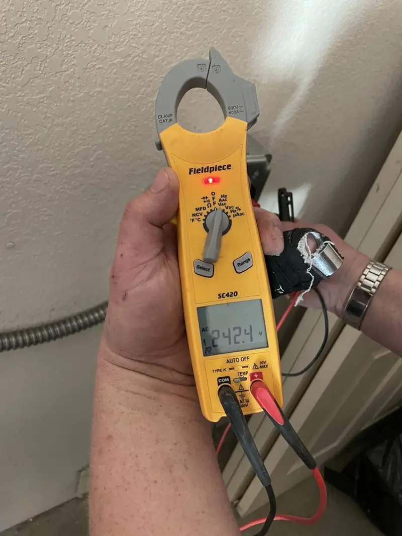 Voltage testing with clamp meter during Ceiling Fan Installation in Lake Wissota